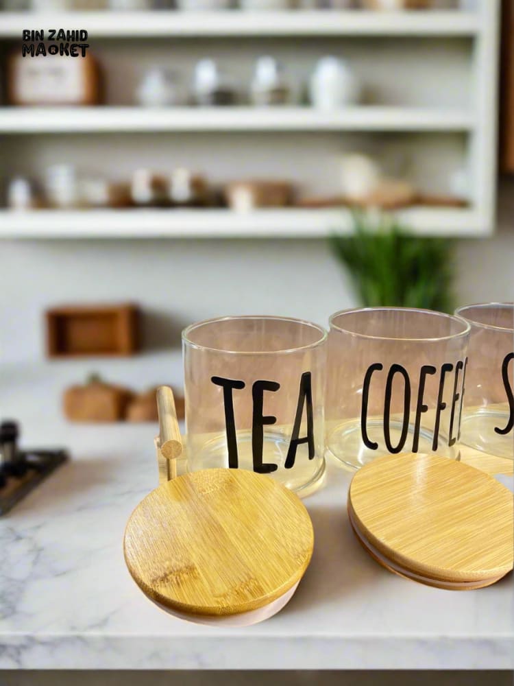 CLEAR GLASS JARS WITH BAMBOO LIDS FOR TEA COFFEE AND SUGAR ON A BAMBOO TRAY — SIMPLE AND STYLISH
