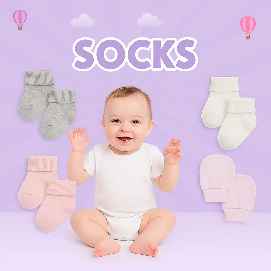 An adorable baby in a white onesie surrounded by various pairs of socks and mittens.
