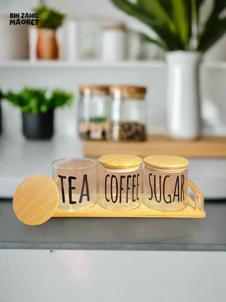 CLEAR GLASS JARS WITH BAMBOO LIDS FOR TEA COFFEE AND SUGAR ON A BAMBOO TRAY — SIMPLE AND STYLISH