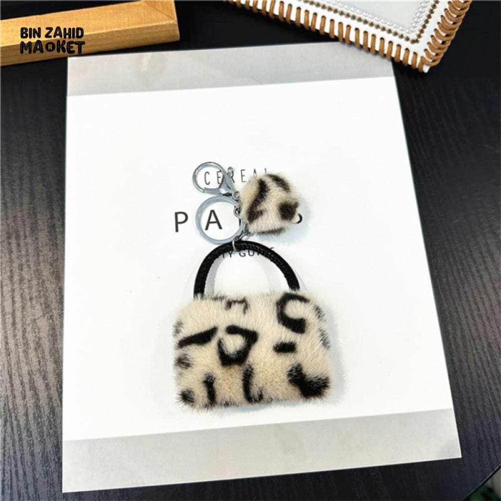 LEOPARD PATTERN BAG KEYCHAIN WITH FLUFFY BEAD — BACKPACK PHONE & CAR ACCESSORY