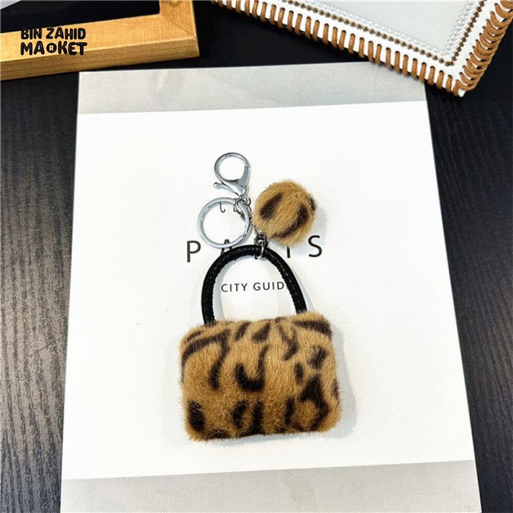 LEOPARD PATTERN BAG KEYCHAIN WITH FLUFFY BEAD — BACKPACK PHONE & CAR ACCESSORY
